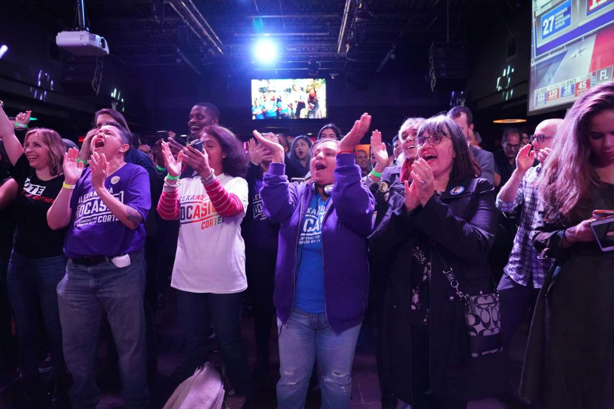 Supporters of Alexandria Ocasio-Cortez cheer during her election night party in Queens, New York on November 6, 2018.
