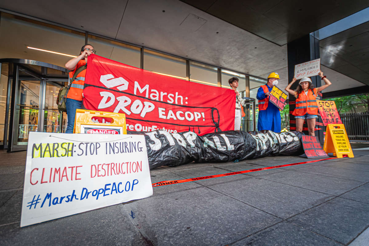 Activists rally outside the headquarters of insurance company Marsh McLennan in New York City, urging CEO Dan Glaser to cut ties with the East African Crude Oil Pipeline (EACOP) on July 1, 2022.