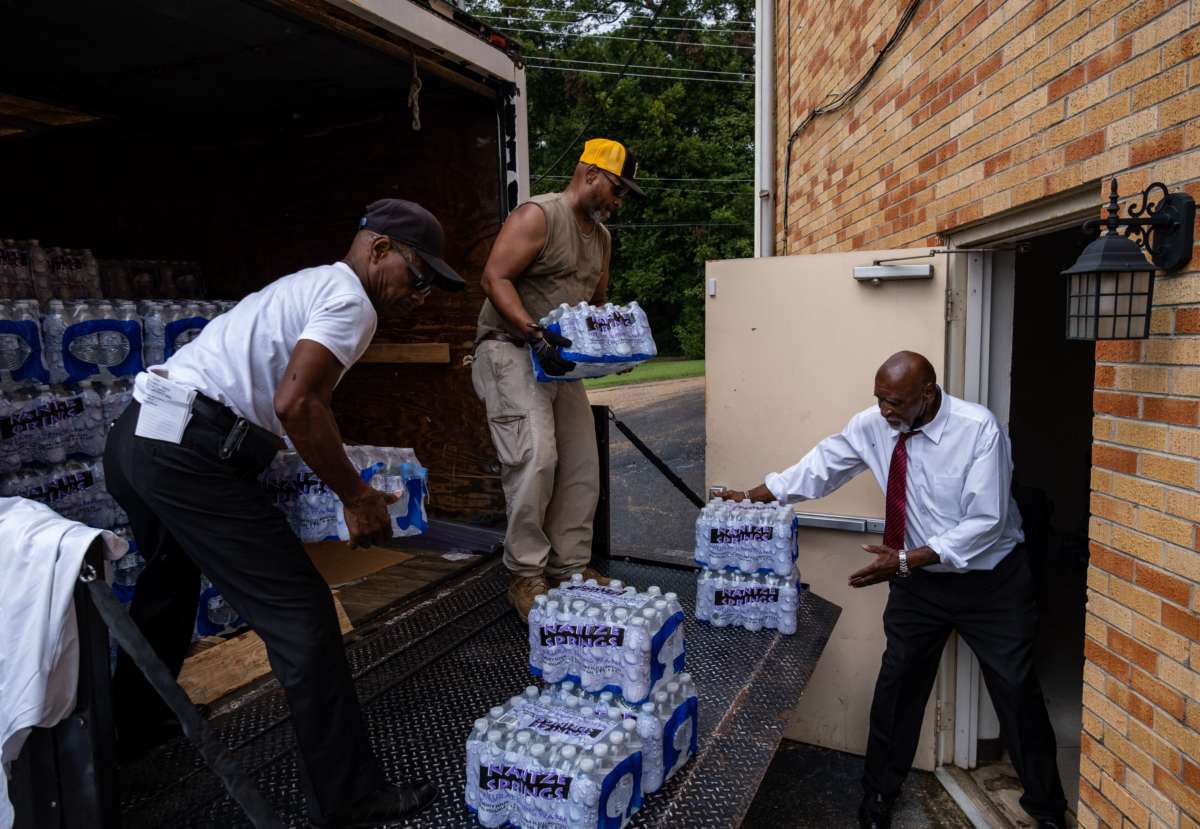 Members of Progressive Morningstar Baptist Church move cases of bottled water in Jackson, Mississippi, on September 4, 2022.