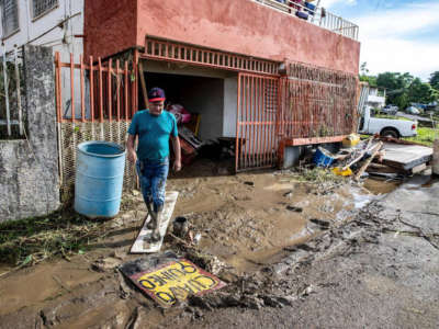 Antonio Perez Miranda walks out of his house through the mud left by flooding caused by Hurricane Fiona in San Jose de Toa Baja, Puerto Rico on September 20, 2022.