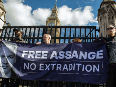 Hundreds of supporters of Julian Assange form a human chain around Parliament to demand the release of the imprisoned whistleblower on October 8, 2022 in London, U.K.