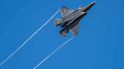 A U.S. F-35 fighter, built by Lockheed Martin, jet flies over the Eifel Mountains near Spangdahlem. The F-35 has cost the government $1.5 trillion in its development, construction and operation.