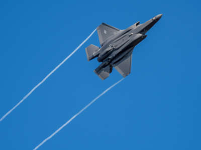 A U.S. F-35 fighter, built by Lockheed Martin, jet flies over the Eifel Mountains near Spangdahlem. The F-35 has cost the government $1.5 trillion in its development, construction and operation.