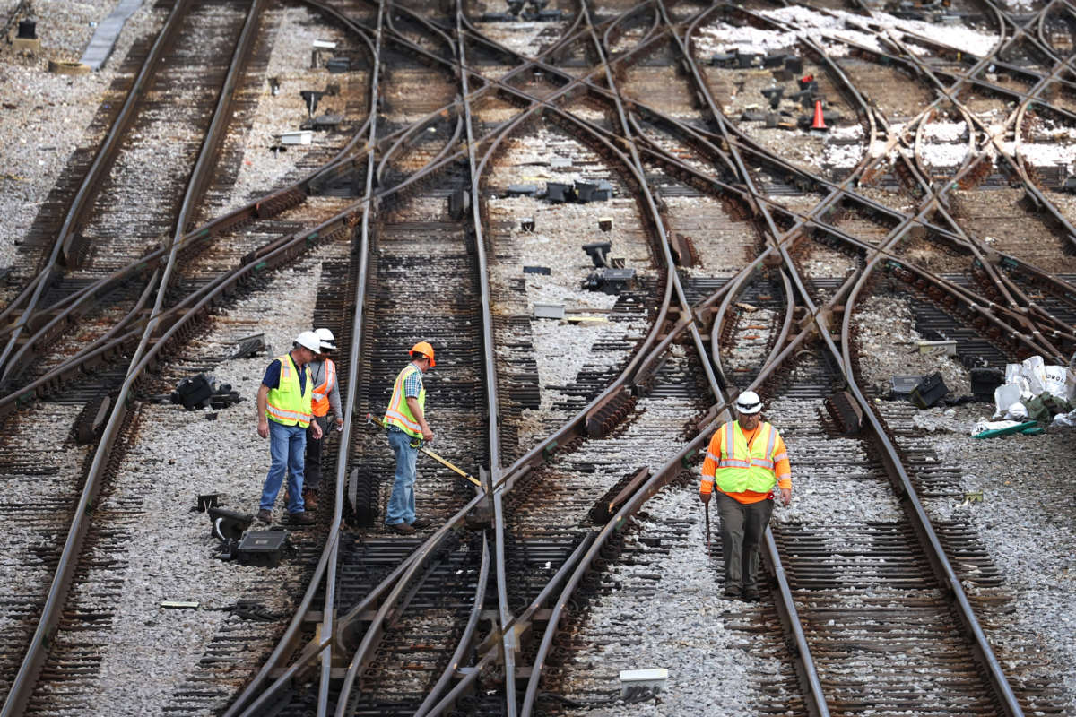 Workers service the tracks at the Metra/BNSF railroad yard outside of downtown on September 13, 2022 in Chicago, Illinois.