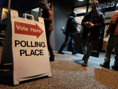 Voters arrive to cast a ballot at a polling station setup in the Region II Elections Office on November 1, 2022, in Anchorage, Alaska.