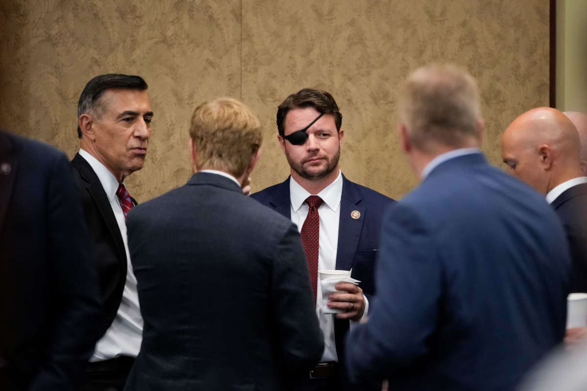 Rep. Dan Crenshaw, center, speaks with fellow House Republican members at the U.S. Capitol on August 30, 2021, in Washington, D.C.