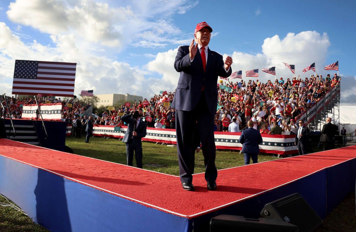 Former President Donald Trump walks on stage during a rally at the Miami-Dade Country Fair and Exposition on November 6, 2022, in Miami, Florida.