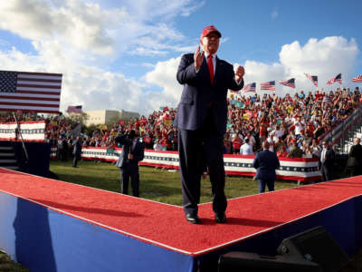 Former President Donald Trump walks on stage during a rally at the Miami-Dade Country Fair and Exposition on November 6, 2022, in Miami, Florida.