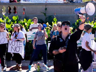 Demonstrators against Amendment 2, which would add a permanent abortion ban to Kentucky's state constitution, counterprotest against the amendment's supporters on the steps of the Kentucky State Capitol in Frankfort, Kentucky, on October 1, 2022.