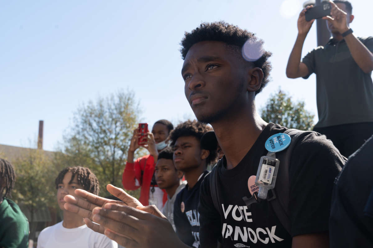 Students clap as Sen. Raphael Warnock speaks at a campaign event at Atlanta University Center Consortium Campus on Election Day on November 8, 2022, in Atlanta, Georgia.