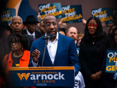 Sen. Raphael Warnock delivers remarks to supporters and attendees at the John Lewis Mural in Atlanta, Georgia, on November 10, 2022.