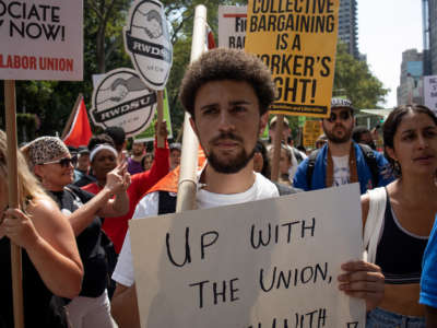 Amazon and Stabucks workers, supported by new service economy unions, march through the streets to protest union busting on Labor Day, September 5, 2022, in New York City.