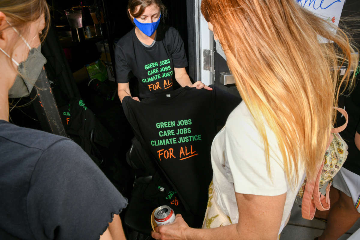 People look at t-shirts at the San Diego Green New Deal Alliance Day: Justice For Mother Earth panel on April 30, 2022, in San Diego, California.