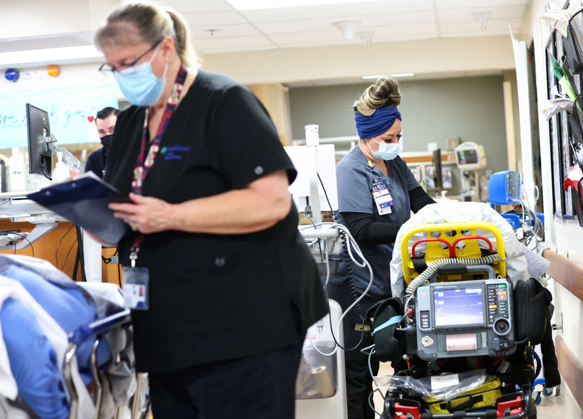 ER technician Priscilla Carrillo, right, cares for a patient in the Emergency Department at Providence St. Mary Medical Center on March 11, 2022, in Apple Valley, California.