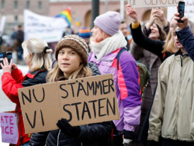 Swedish climate activist Greta Thunberg attends a climate demonstration called by youth-led organization Auroras before submitting its lawsuit against the state for their lack of climate work, in Stockholm on November 25, 2022.