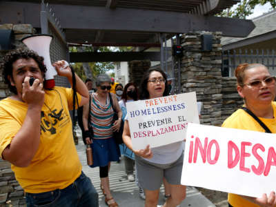Betty Gabaldo, center, marches with tenants and activists after a rally at the Delta Pines apartment complex in Antioch, California, on June 22, 2022.