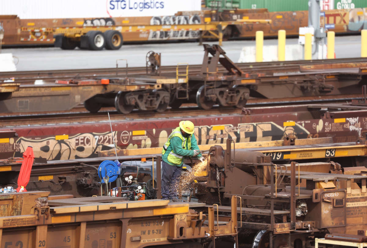 A worker is seen in a Union Pacific Intermodal Terminal rail yard on November 21, 2022, in Los Angeles, California.