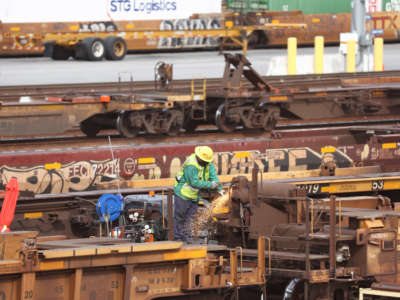 A worker is seen in a Union Pacific Intermodal Terminal rail yard on November 21, 2022, in Los Angeles, California.