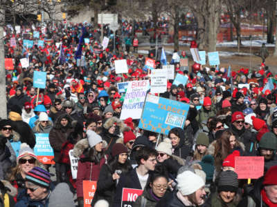 Teachers and education workers from the four major education unions walk a picket line around Queens Park Circle in Toronto during a previous strike, February 21, 2020.