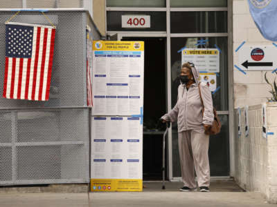 A woman who is living at the Union Rescue Mission cast her vote at the James Wood Community Center at in downtown Los Angeles on June 7, 2022.