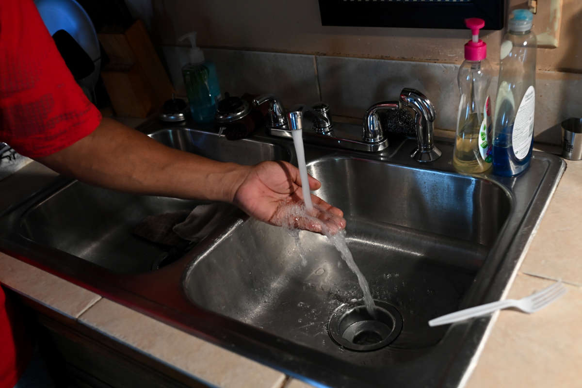 Timbo Payne checks the water pressure in his kitchen at his home on September 3, 2022 in Jackson, Mississippi.