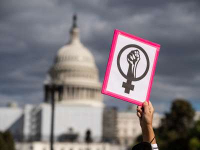 An abortion rights demonstrator holds a sign near the U.S. Capitol during the annual Women's March to support women's rights in Washington, D.C, October 8, 2022.