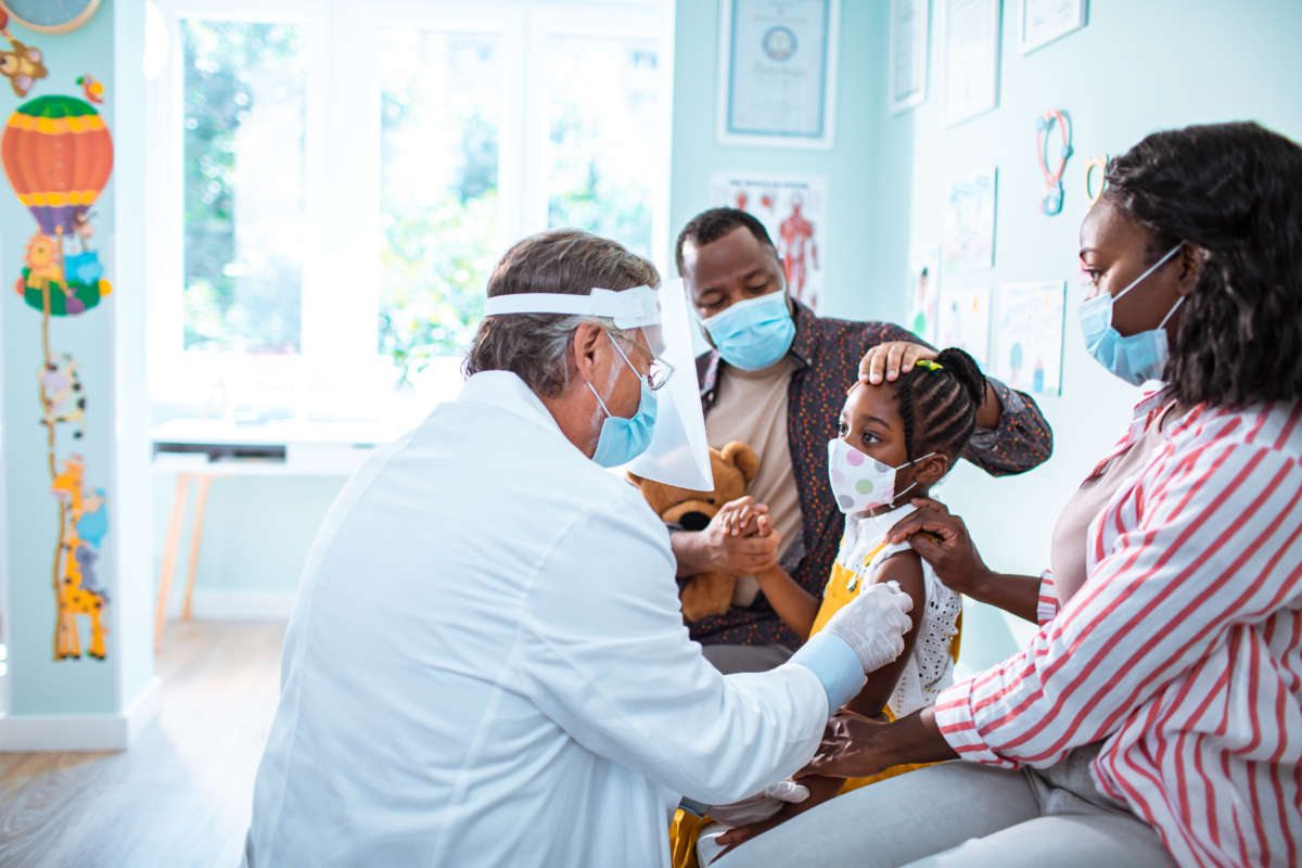 Close up of a little girl getting vaccinated by her pediatrician