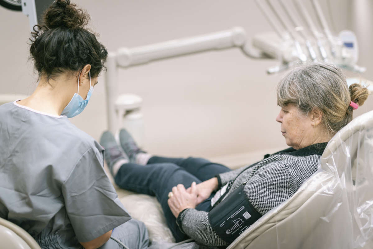 A senior woman gets her blood pressure taken during a doctor appointment