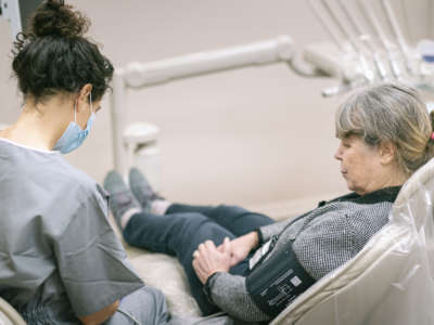 A senior woman gets her blood pressure taken during a doctor appointment