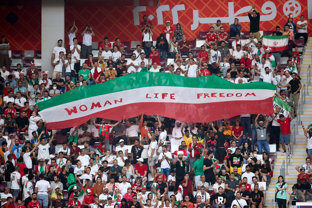 Iranian fans hold up a banner that says "Woman Life Freedom" during the FIFA World Cup Qatar 2022 Group B match between England and Iran at Khalifa International Stadium on November 21, 2022, in Doha, Qatar.