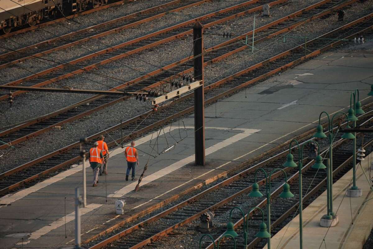 Railway workers walk through Union Station in Washington, DC, on September 15, 2022. President Joe Biden announced on September 15 that union leaders and rail companies had reached a "tentative" deal on a contract the previous weekend.