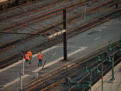 Railway workers walk through Union Station in Washington, DC, on September 15, 2022. President Joe Biden announced on September 15 that union leaders and rail companies had reached a "tentative" deal on a contract the previous weekend.