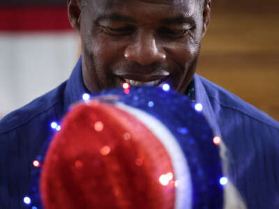 Georgia Republican senate candidate Herschel Walker talks with supporters after a campaign rally on November 30, 2022, in Dalton, Georgia.