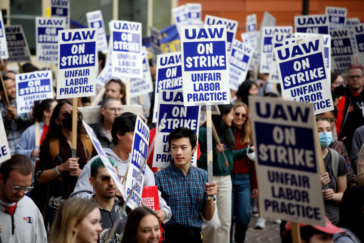 University of California academic workers strike as they walk along the picket line on the campus of the University of California, Los Angeles, on November 28, 2022.