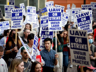 University of California academic workers strike as they walk along the picket line on the campus of the University of California, Los Angeles, on November 28, 2022.