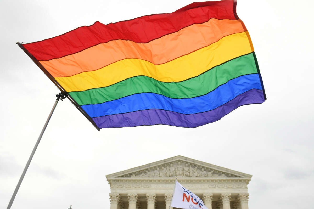 Demonstrators in favor of LGBT rights rally outside the Supreme Court in Washington, D.C., on October 8, 2019.