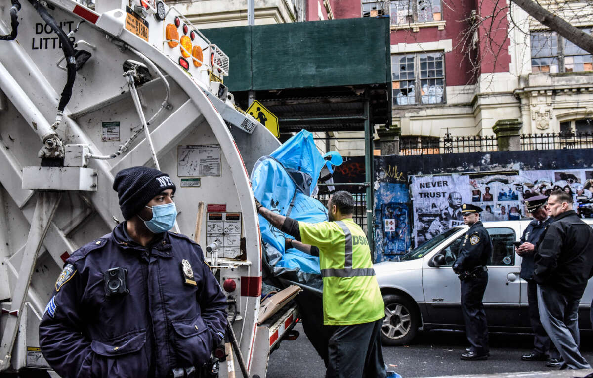 A tent from the homeless encampment is destroyed as New York City police work with the Department of Sanitation to clear a homeless encampment near Tompkins Square Park on April 6, 2022, in the Manhattan borough in New York City.