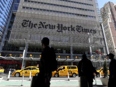 People walk along 8th Avenue in front of the New York Times headquarters on March 9, 2020, in New York City.