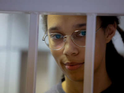 U.S.' Women's National Basketball Association basketball player Brittney Griner, who was detained at Moscow's Sheremetyevo airport, stands inside a defendants' cage before a court hearing in Khimki outside Moscow, on August 4, 2022.