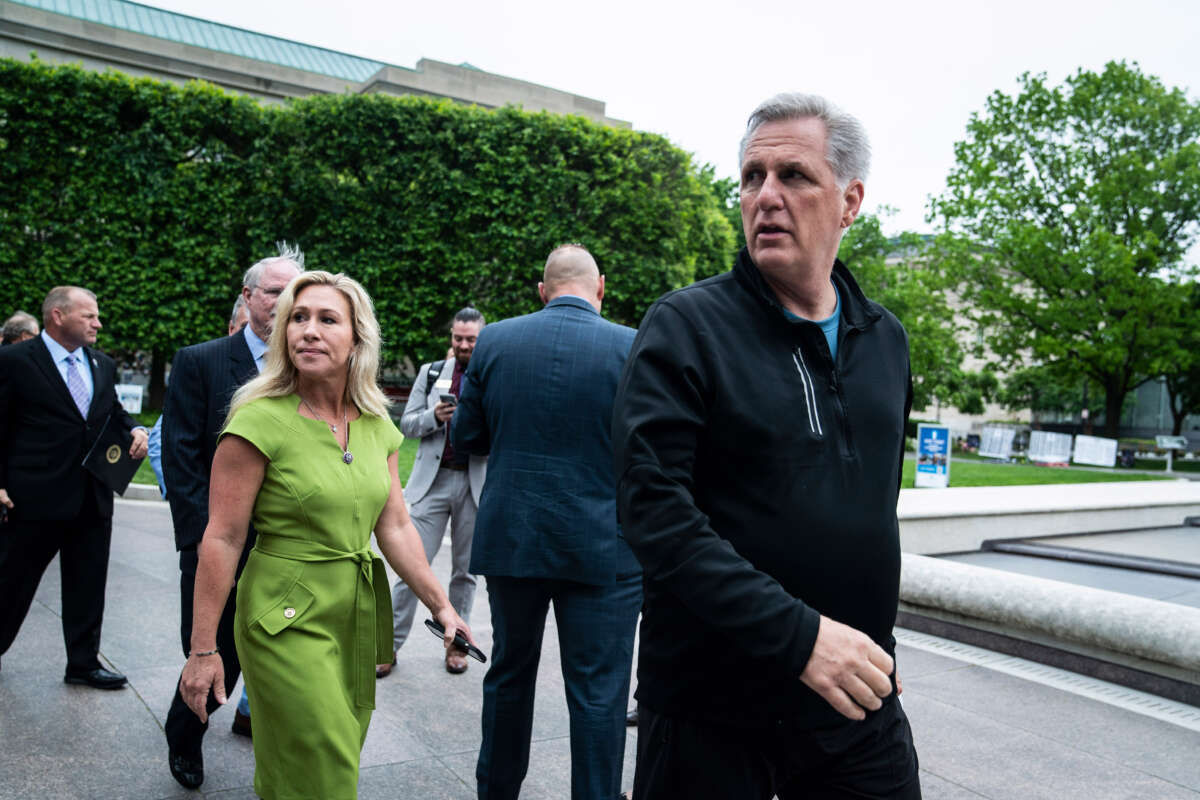 House Minority Leader Kevin McCarthy and Rep. Marjorie Taylor Greene walk to a press conference on May 12, 2022, in Washington, D.C.