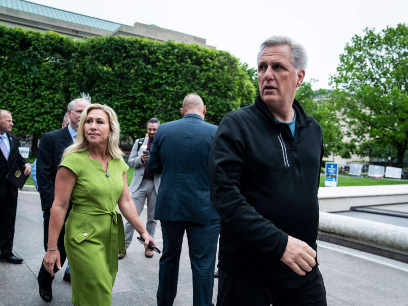 House Minority Leader Kevin McCarthy and Rep. Marjorie Taylor Greene walk to a press conference on May 12, 2022, in Washington, D.C.