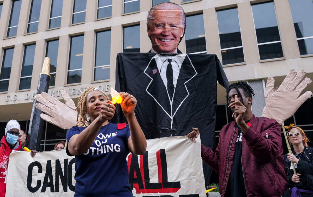 Maddy Clifford burns a slip of paper representing her debt in front of the Department of Education as part of the Debt Collective Day of Action in April 2022.