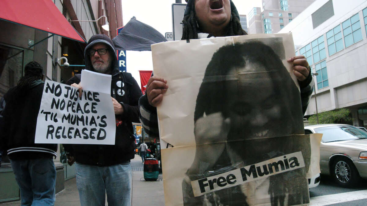 A supporter of Mumia Abu-Jamal emotionally chants no justice no peace until Mumia is released outside the Criminal Justice Center on April 24, 2017.