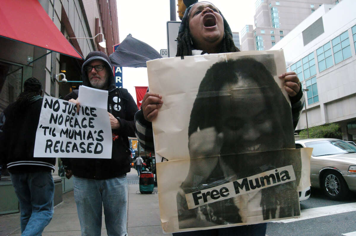 A supporter of Mumia Abu-Jamal emotionally chants no justice no peace until Mumia is released outside the Criminal Justice Center on April 24, 2017.