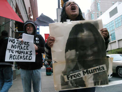 A supporter of Mumia Abu-Jamal emotionally chants no justice no peace until Mumia is released outside the Criminal Justice Center on April 24, 2017.