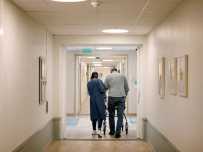 Nurse helps senior citizen at nursing home