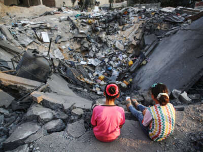 Palestinian children inspect their damaged building in Gaza City on August 9, 2022.