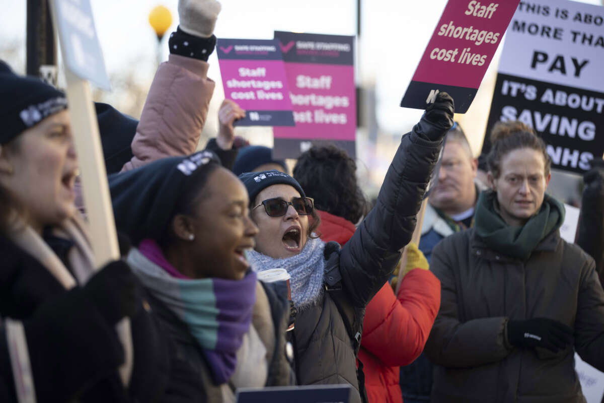 Demonstrators, holding placards and banners, gather during a strike by NHS nursing staff outside St. Thomas' Hospital in London, United Kingdom, on December 15, 2022.