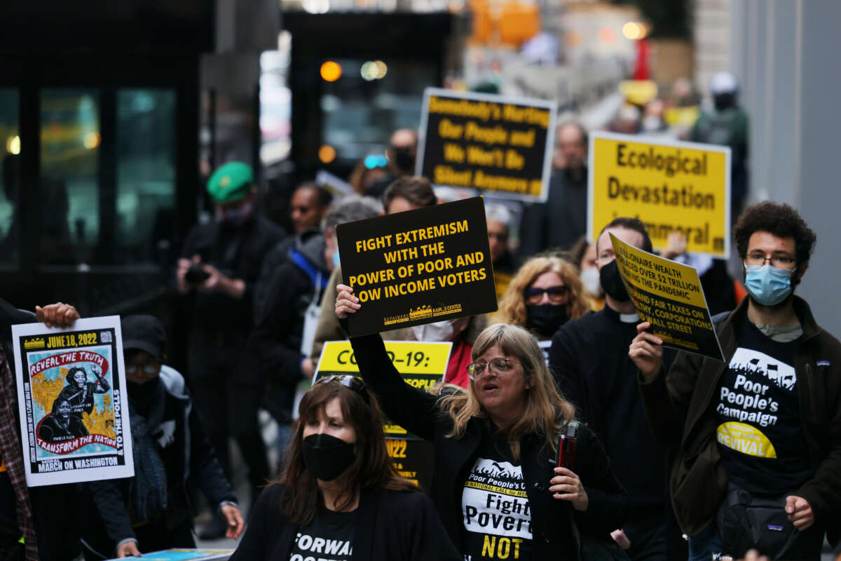 People participate in a march to Trinity Church for a moral Mass on April 11, 2022, in New York City.