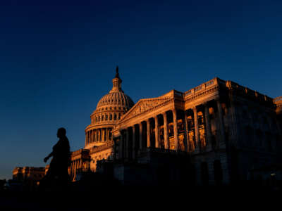 A pedestrian walks past the U.S. Capitol in Washington, D.C., on September 14, 2022.